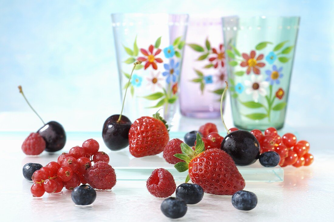Berries and cherries, patterned glasses in background