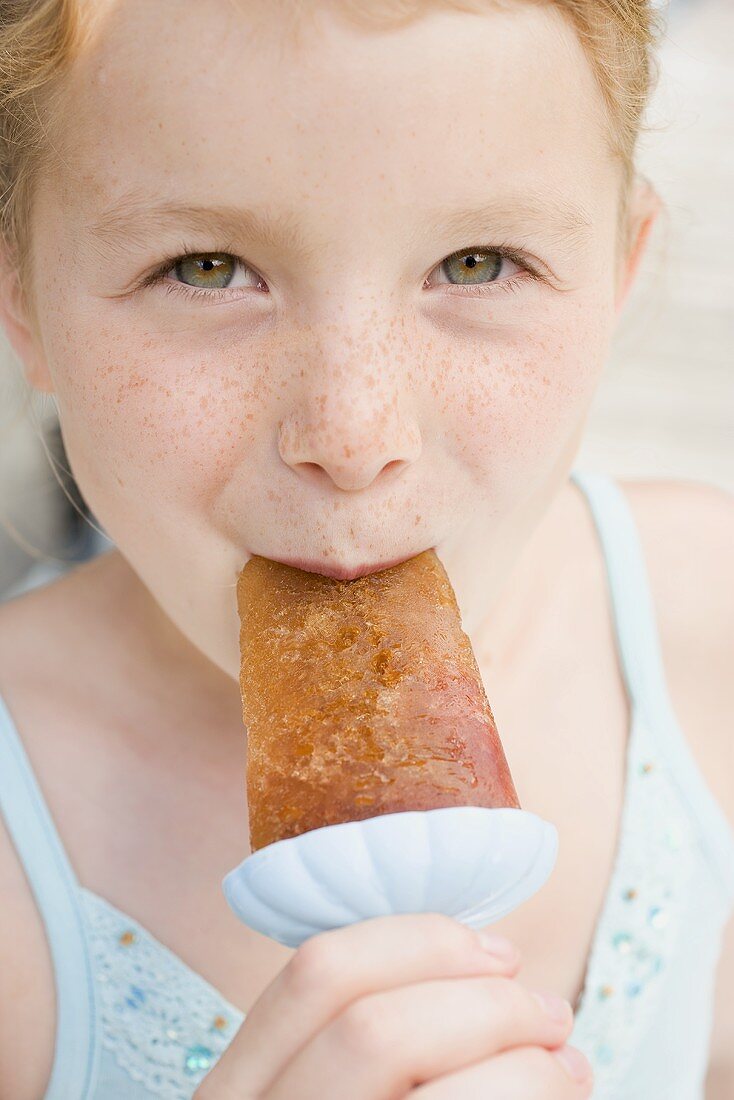 Girl eating ice lolly