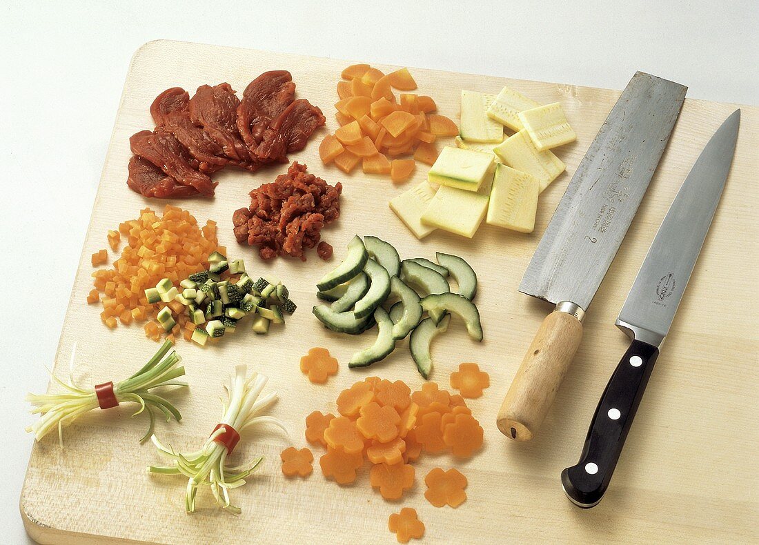 Chopped Vegetables and Meat on Cutting Board; Knives