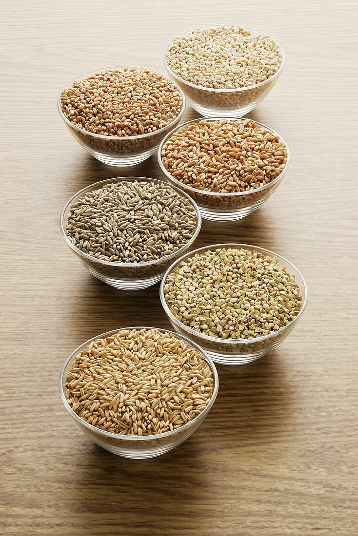 Various cereal grains in glass bowls