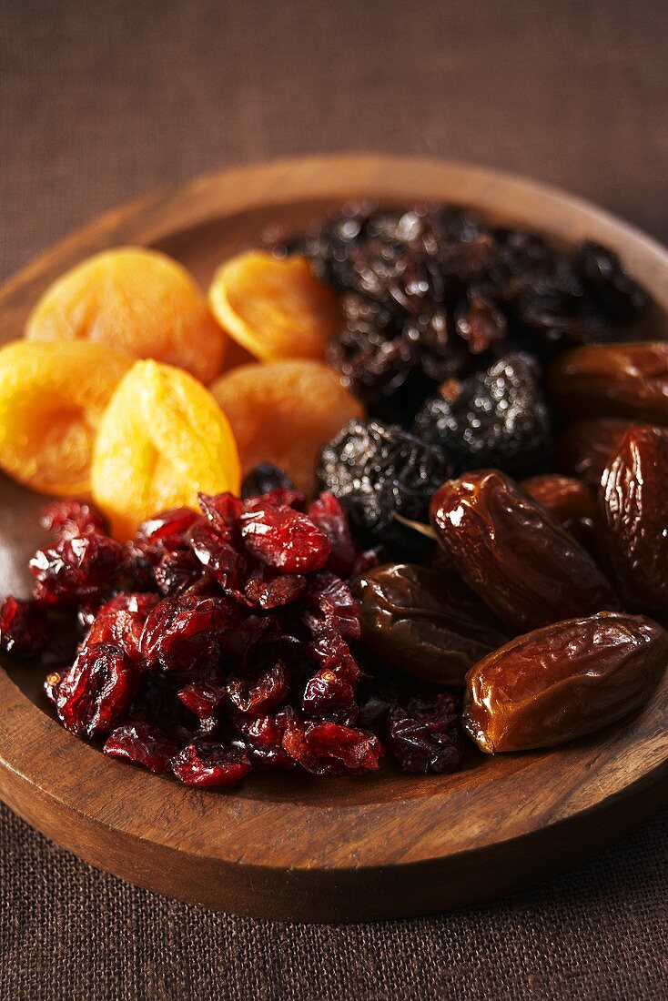 Assorted dried fruit in a wooden dish