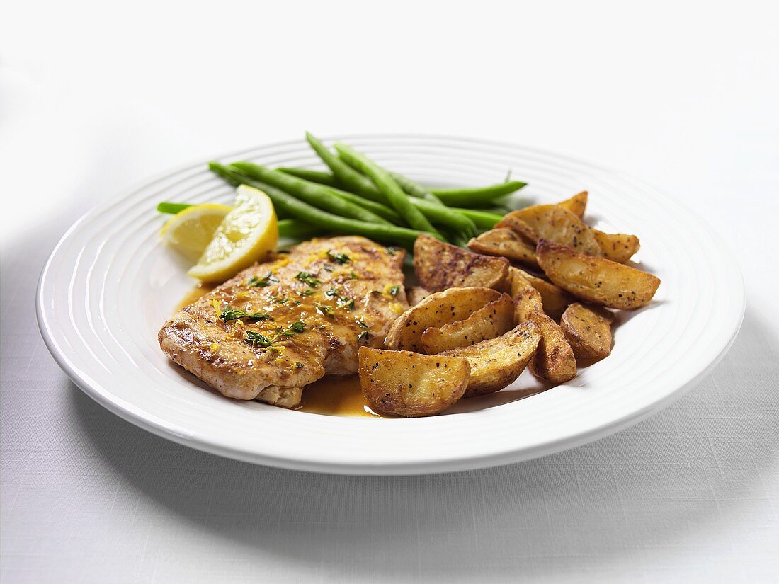 Chicken escalope with potato wedges and green beans
