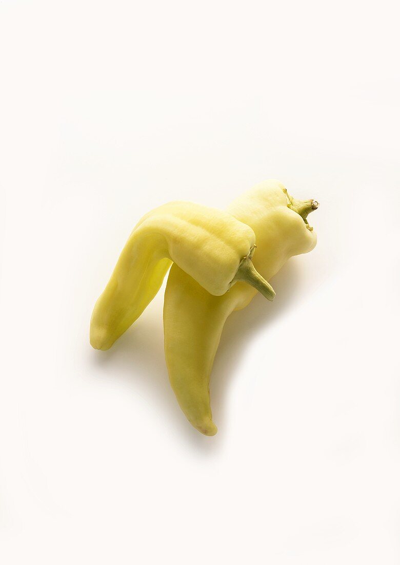 Two yellow pointed peppers