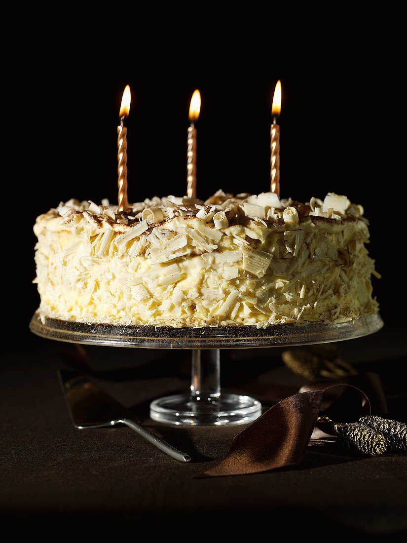 Chocolate coffee cake with three candles
