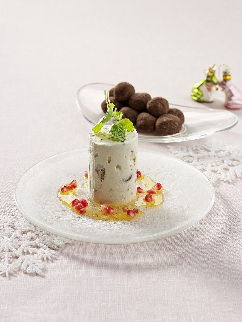 Parfait with pomegranate seeds, chocolate truffles behind