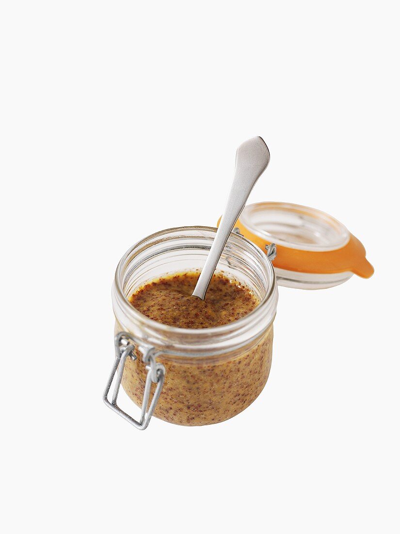 Mustard in jar with spoon