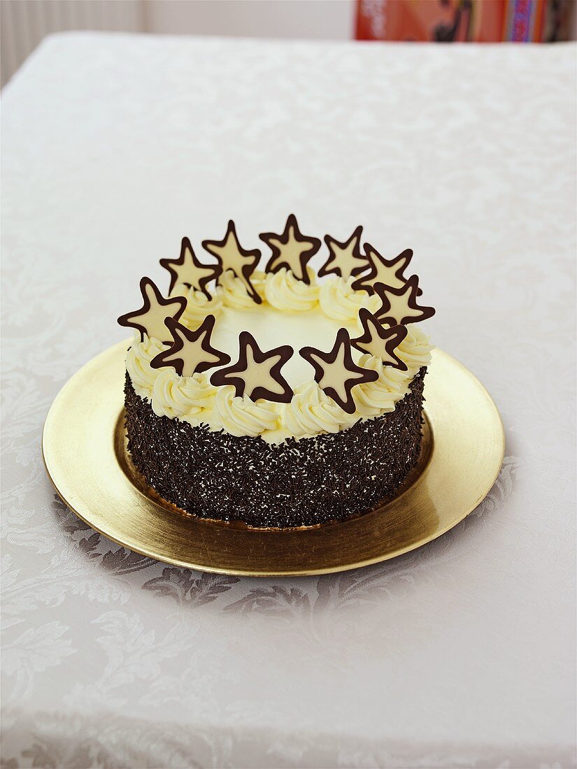 Cream cake with chocolate sprinkles and stars