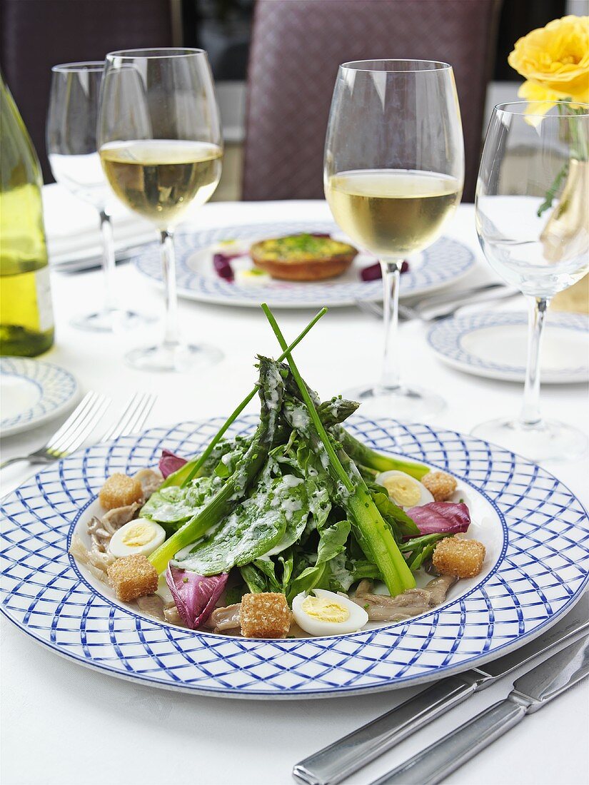 Asparagus and spinach salad with quail's egg, croutons & cheese dressing