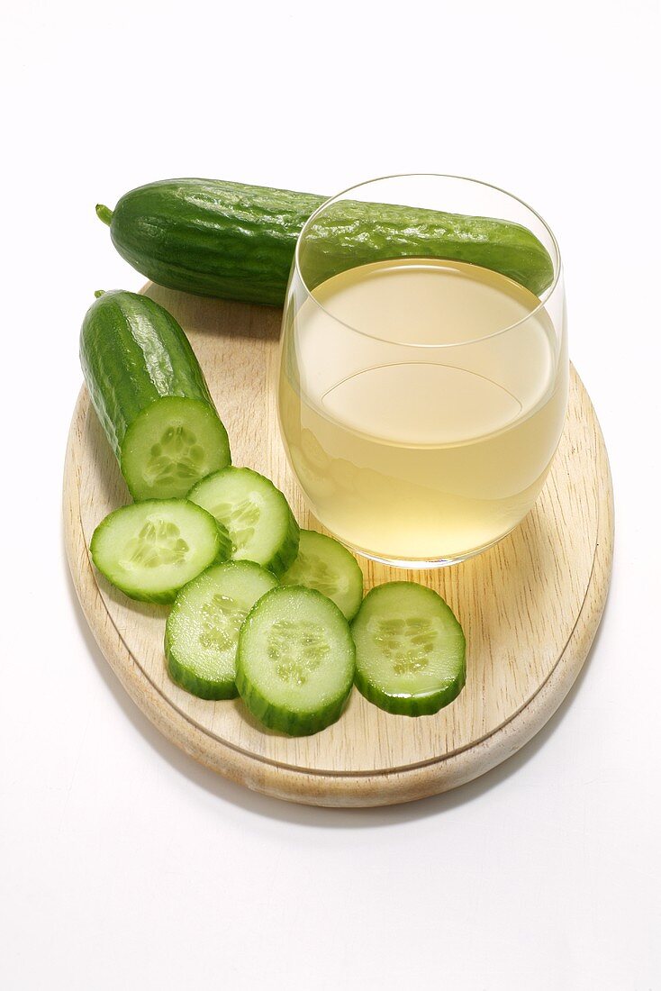 A glass of cucumber juice and cucumbers