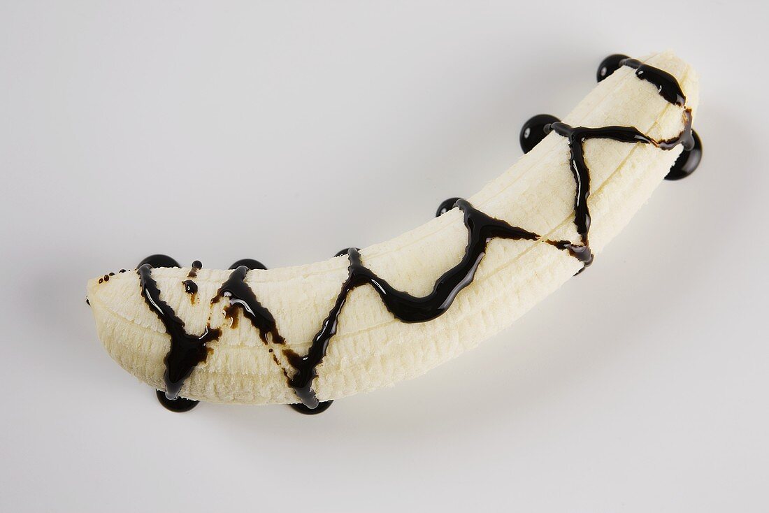 Peeled banana with balsamic cream