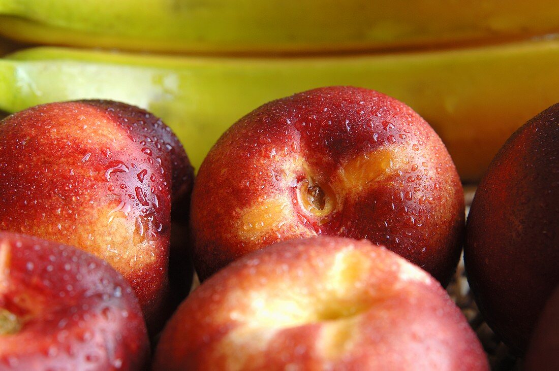 Nectarines and bananas with drops of water (detail)