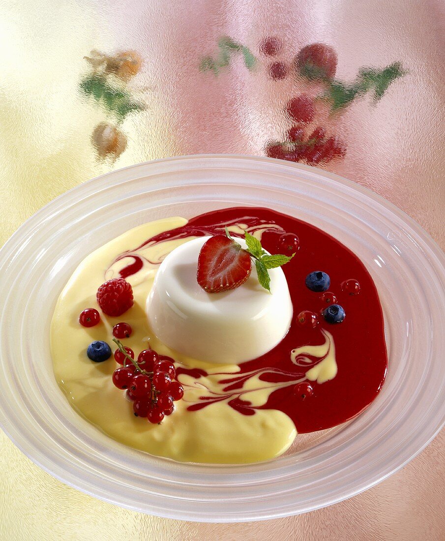 Moulded yoghurt dessert with strawberry sauce and custard
