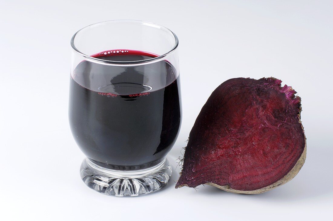 A glass of beetroot juice and a beetroot