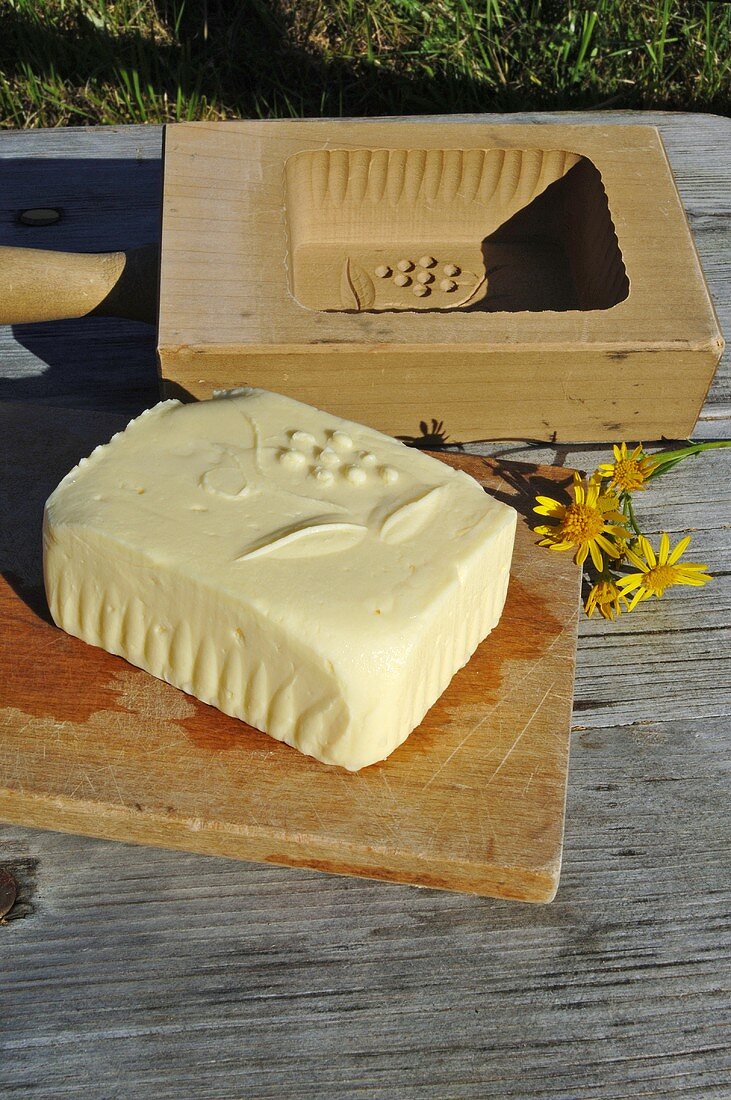 Fresh Alpine butter and wooden butter mould