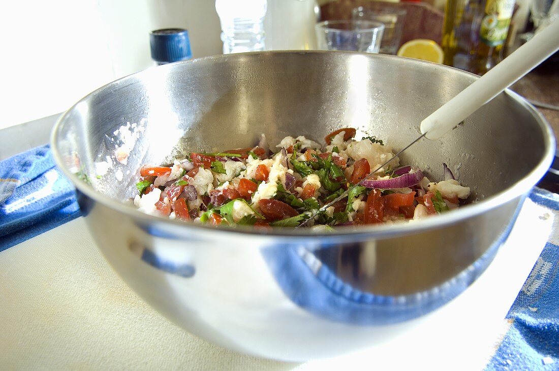 Fish and tomato salad with coriander in a bowl