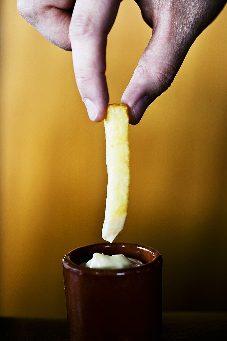 Pommes frites in Mayonnaise dippen