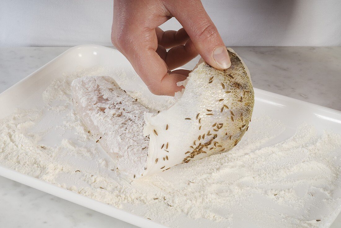 Coating zander fillet in flour