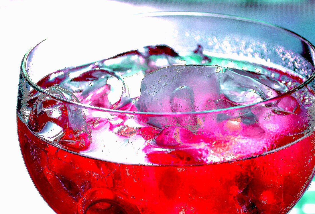 Red fruit cocktail with ice cubes
