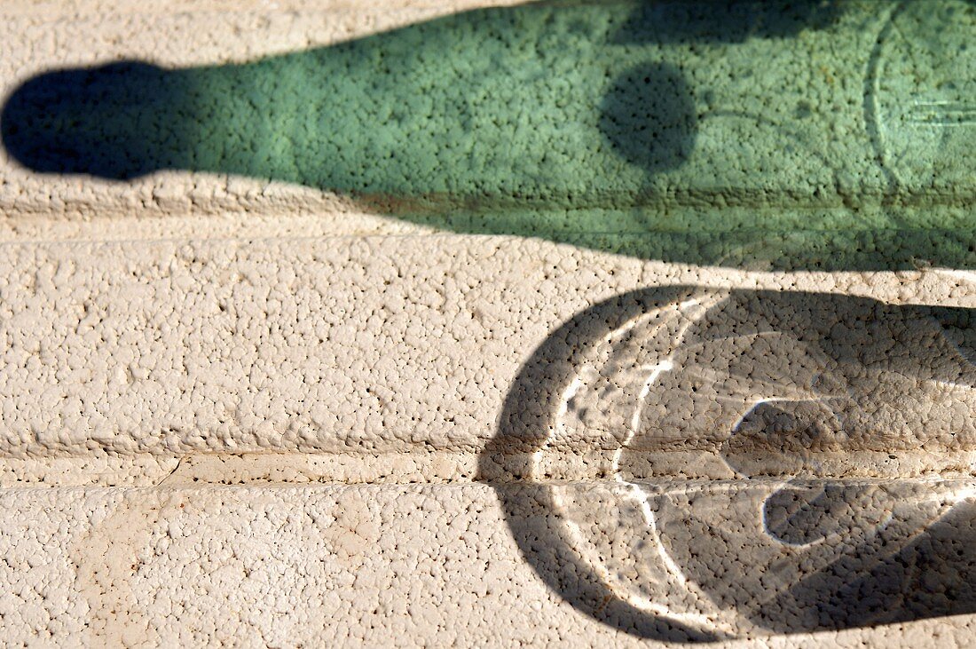 Shadows of a glass of water and a bottle of water