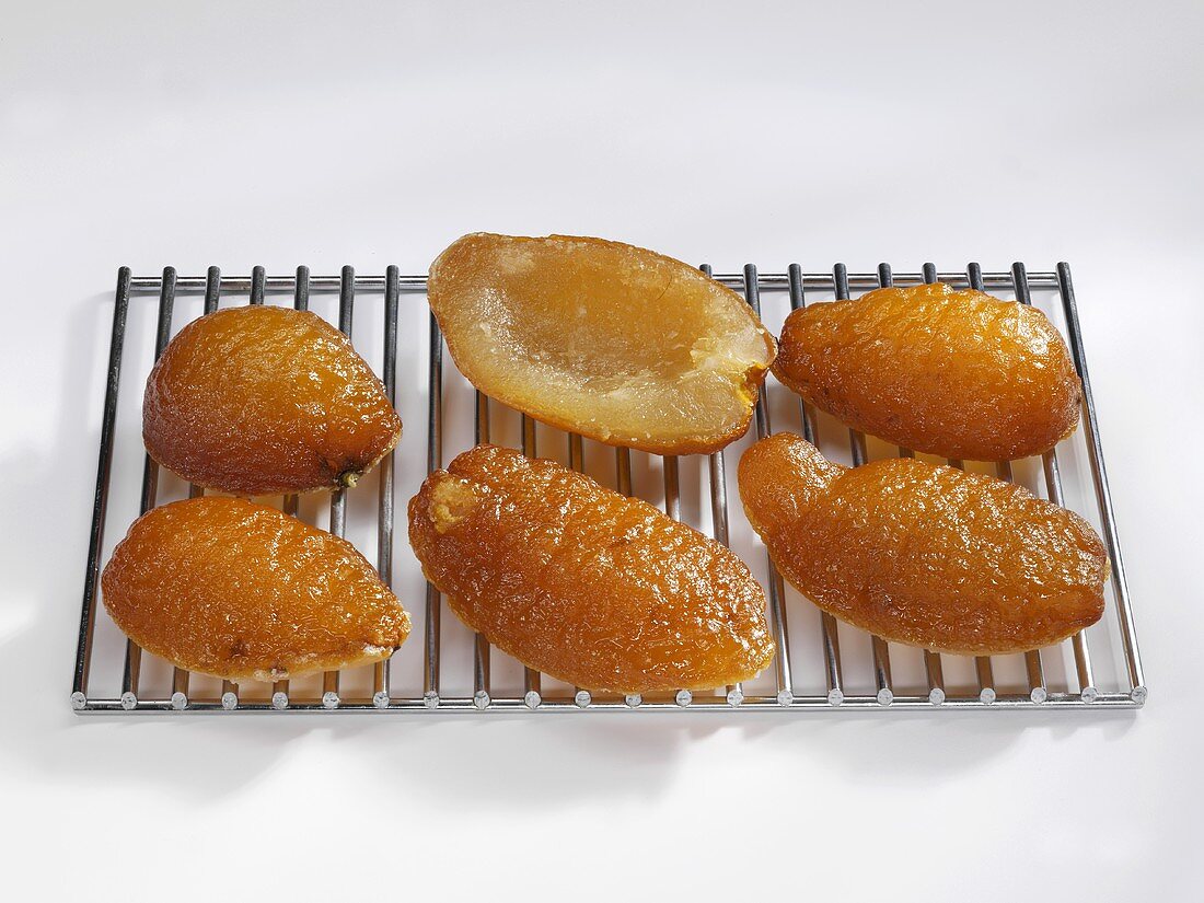 Six candied citron halves on a rack