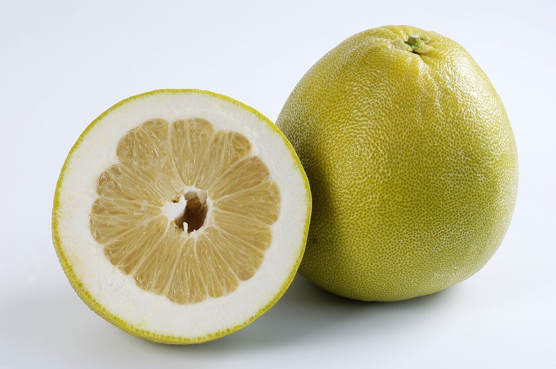 A whole pomelo and half a pomelo