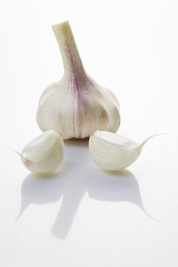 A garlic bulb and two cloves of garlic