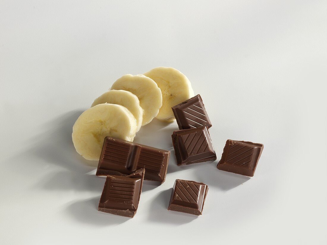 Mehrere Schokoladenstücke und Bananenscheiben
