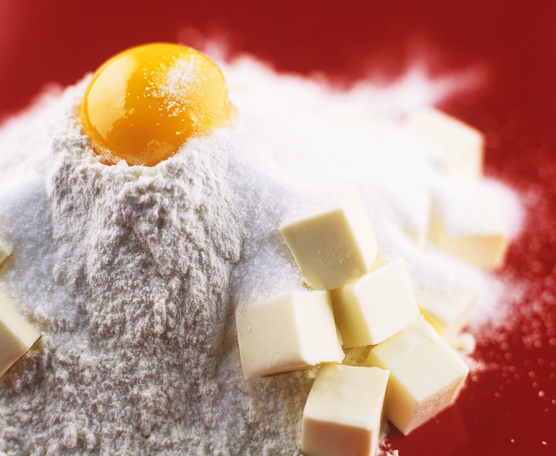 Ingredients for sweet pastry: flour, egg, sugar and butter
