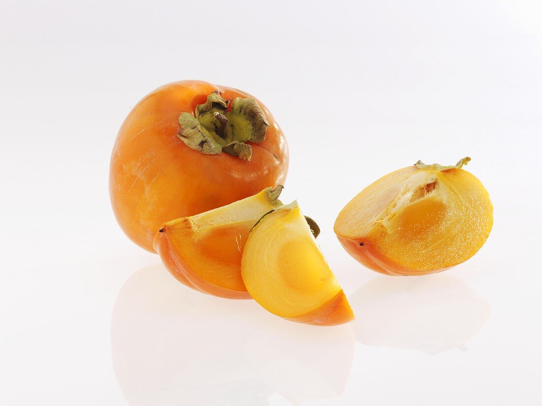 Persimmons, whole and sliced