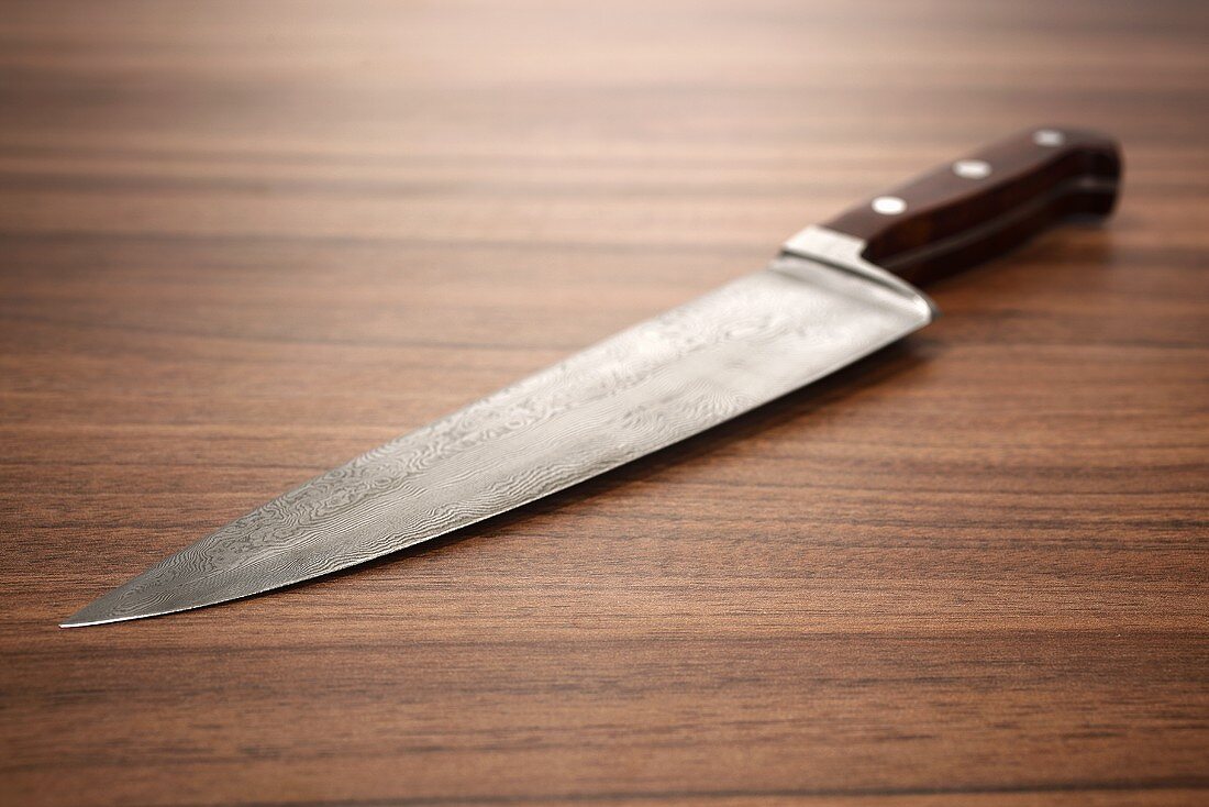 A kitchen knife on a wooden surface