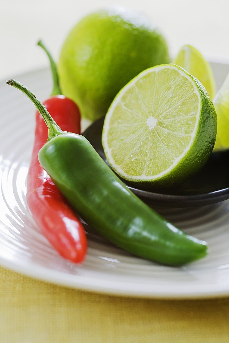 Limes with green and red chili peppers