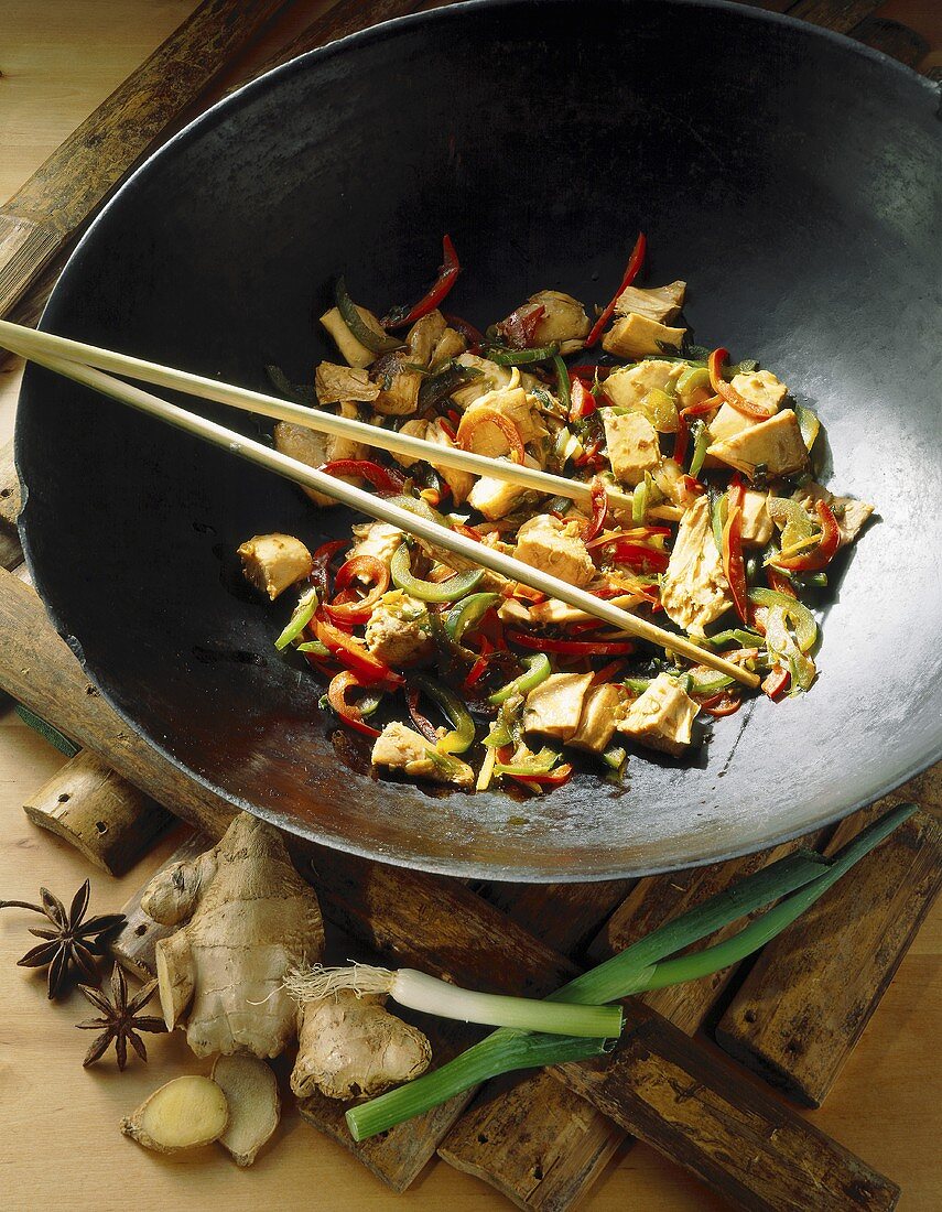 Chicken with Oriental spices in a wok