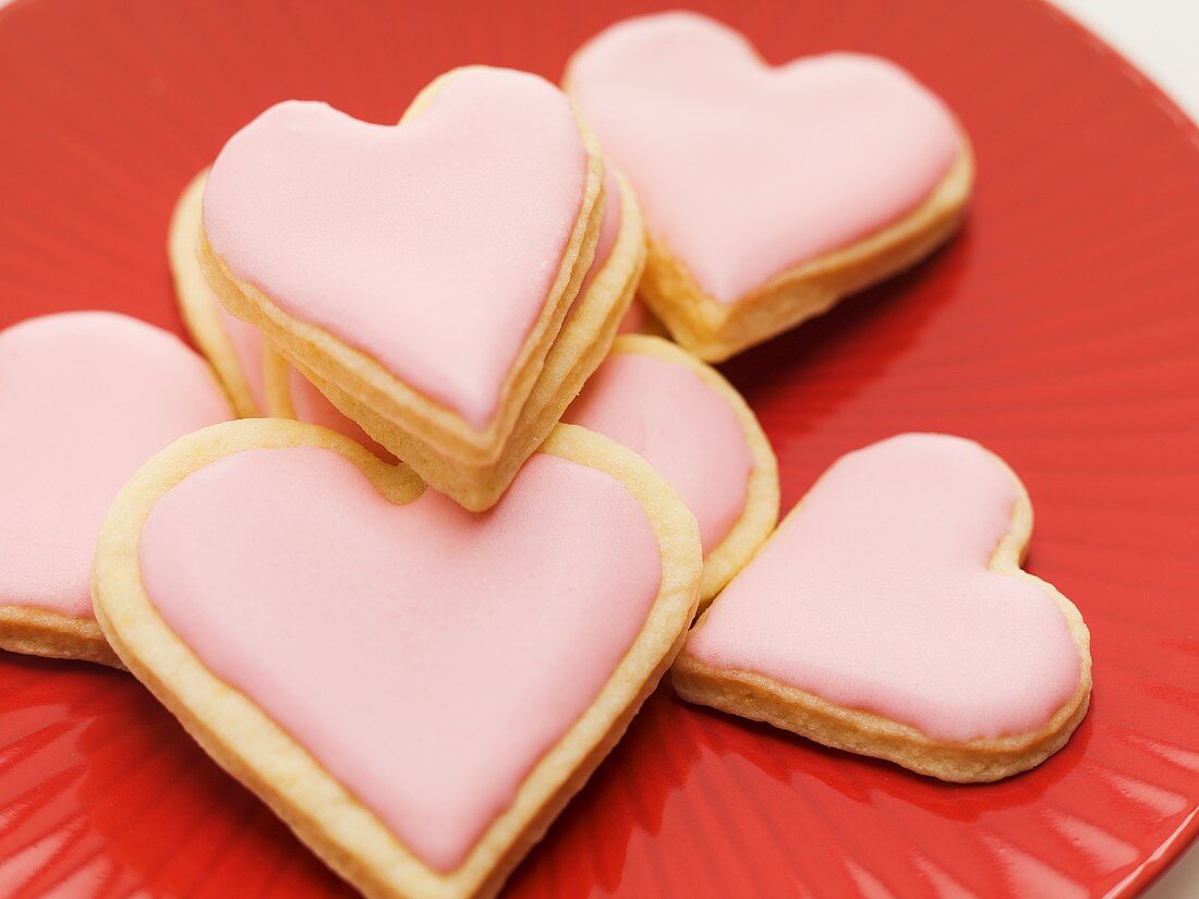 Pink heart-shaped biscuits on plate