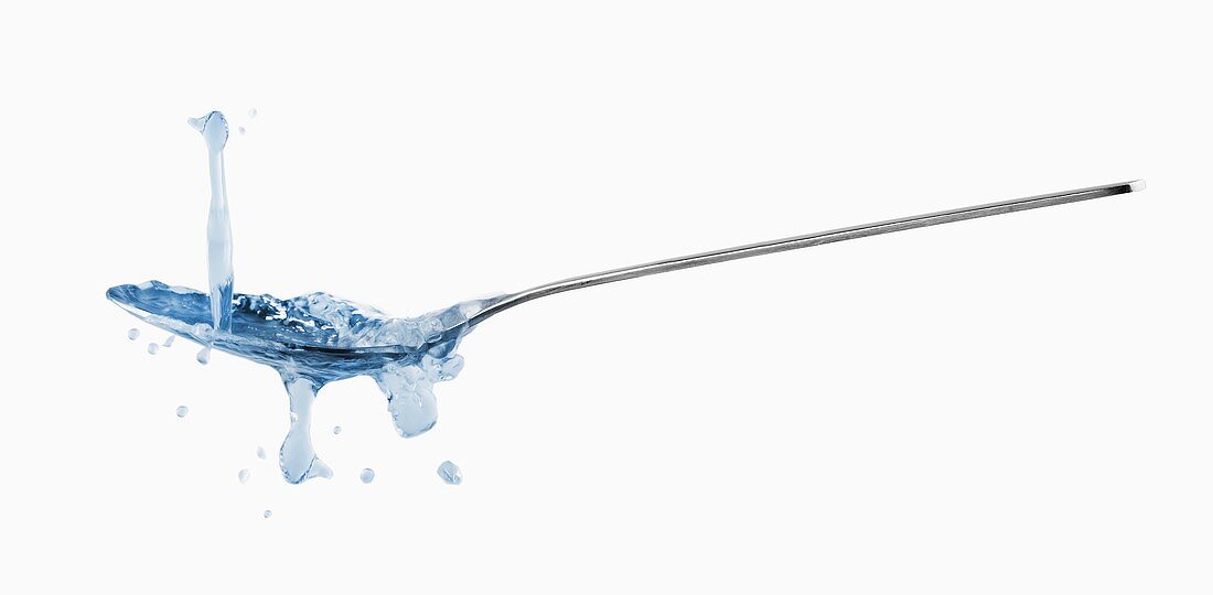 Spoon with splashing water