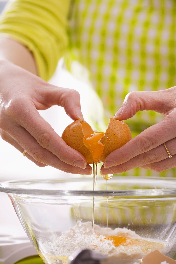 Separating an egg and putting it into a mixing bowl