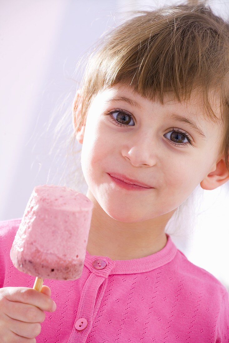 Girl with raspberry yoghurt ice cream