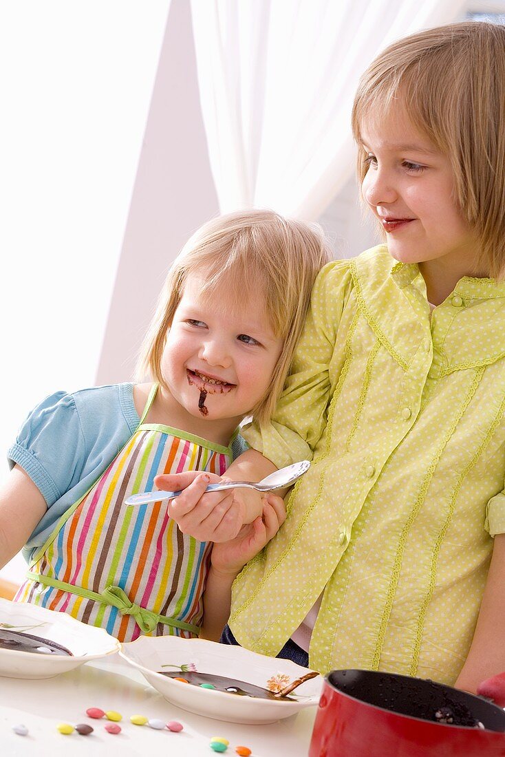 Two girls tasting chocolate dessert