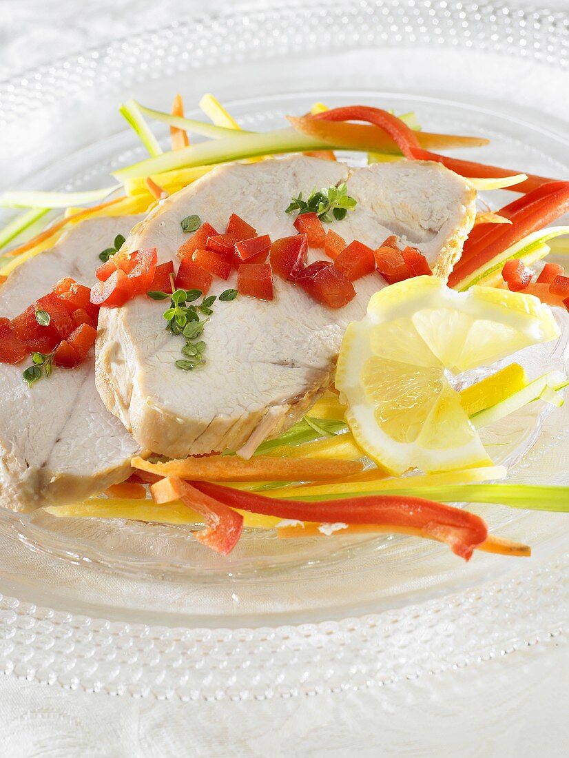 Roast turkey on root vegetables with red pepper and lemon
