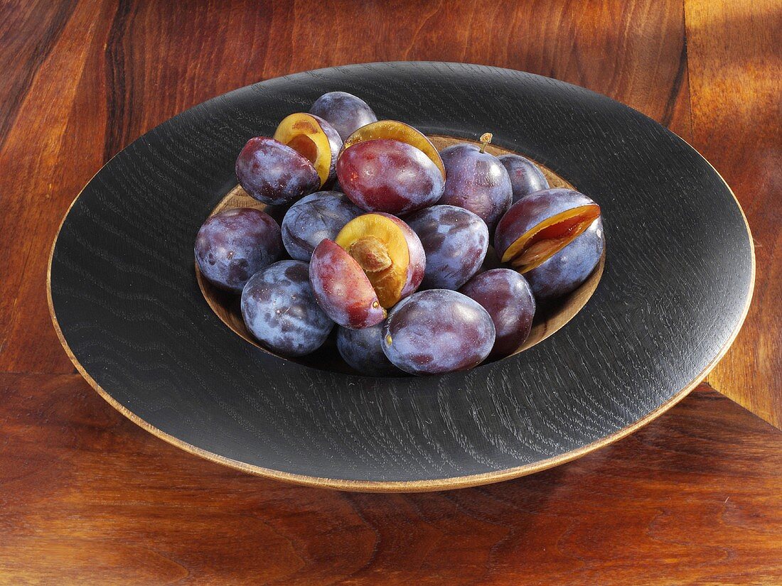 Plums in a wooden dish