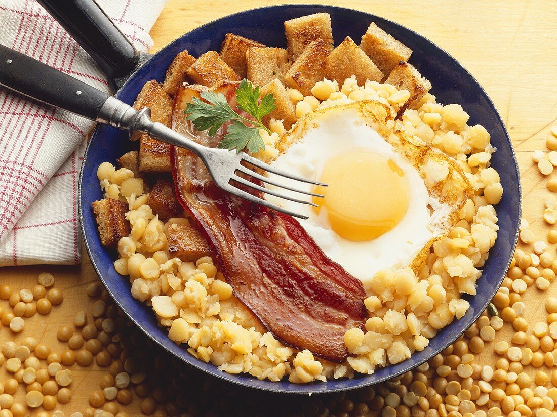Fried egg and bacon on chick-peas