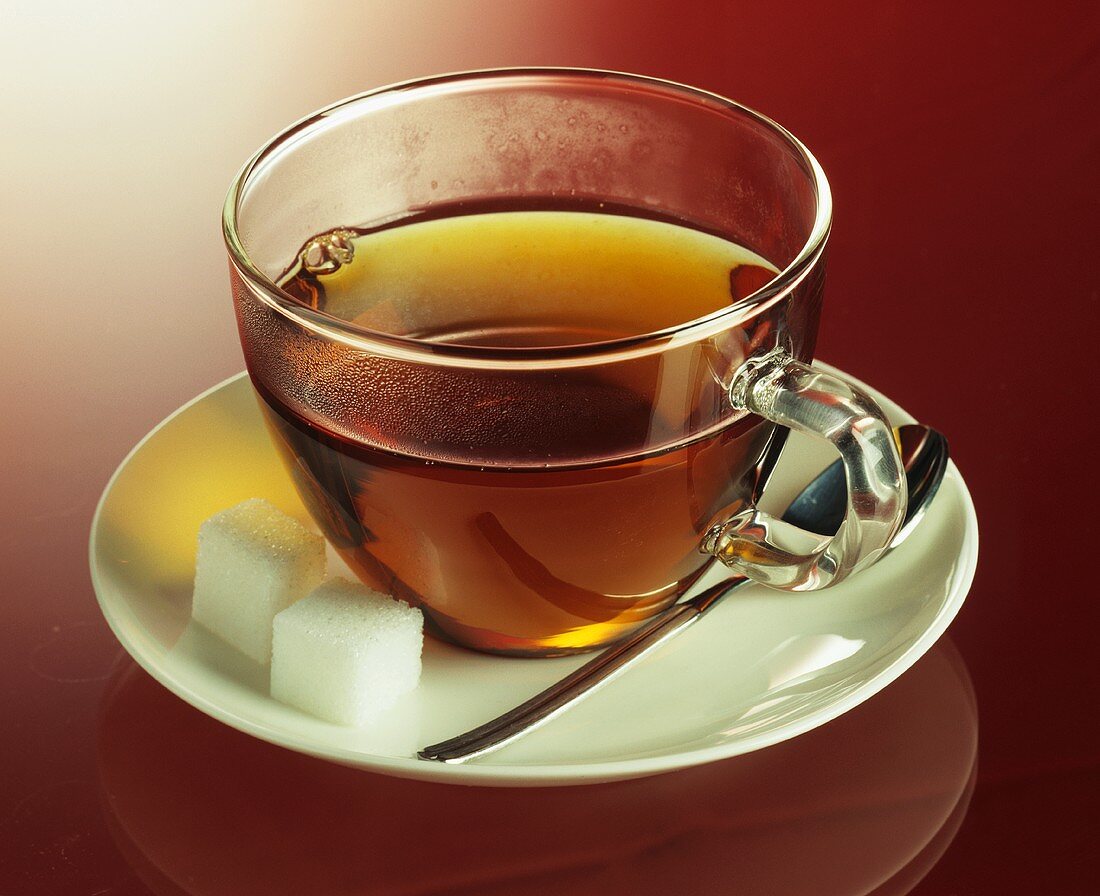 A cup of tea with sugar cubes