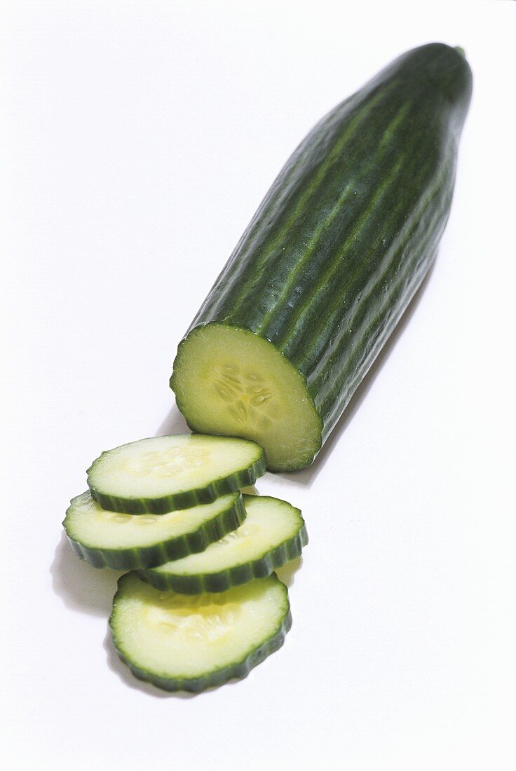 A cucumber, partly sliced