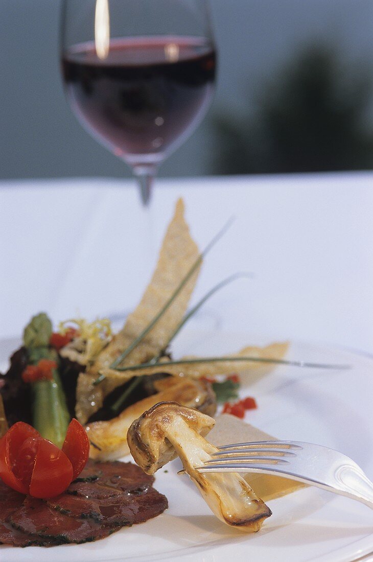 Beef carpaccio with grilled ceps, vegetables and red wine