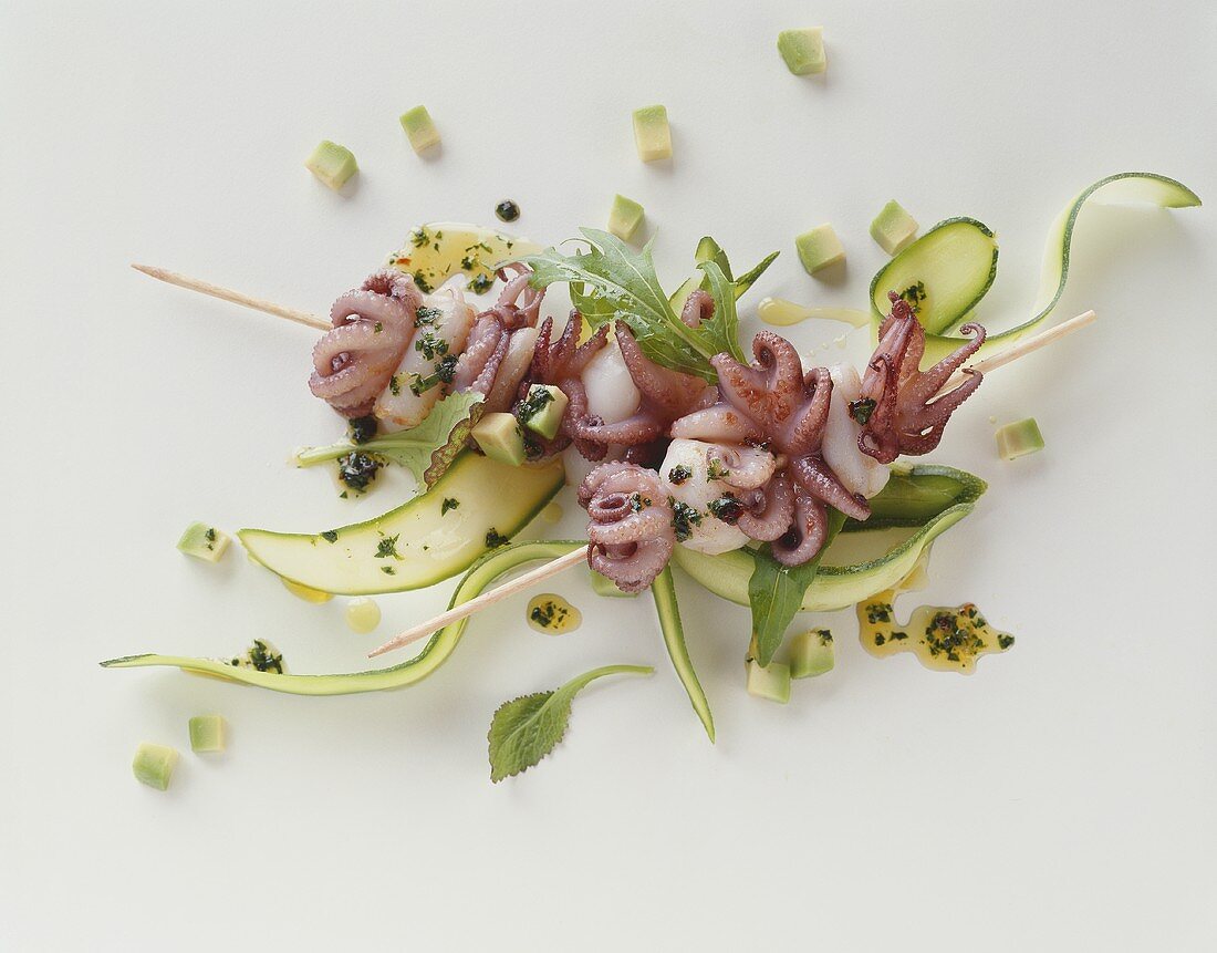 Skewered calamari on courgette ribbons and diced avocado