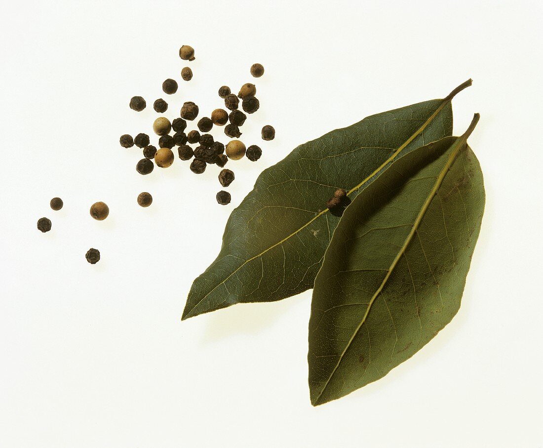 Two bay leaves, white and black peppercorns