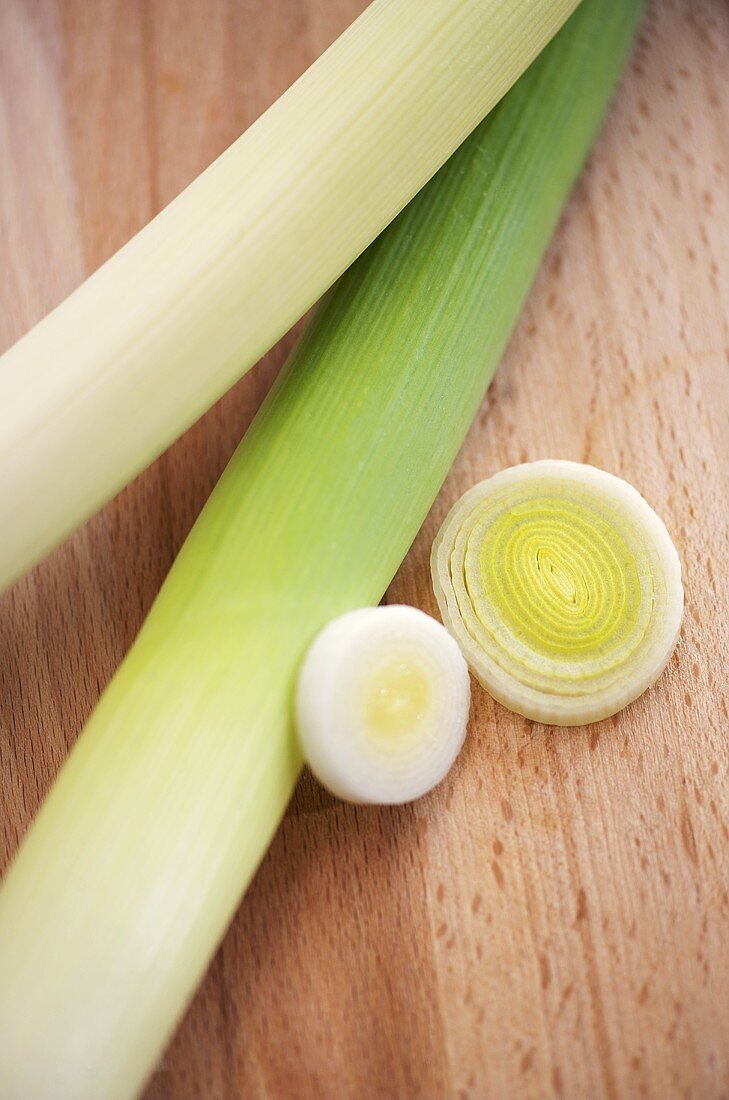 Leeks and leek rings on wooden background