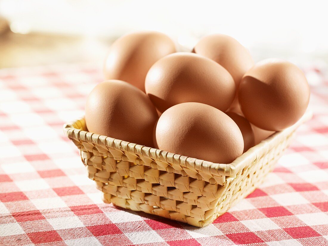Brown eggs in a small basket