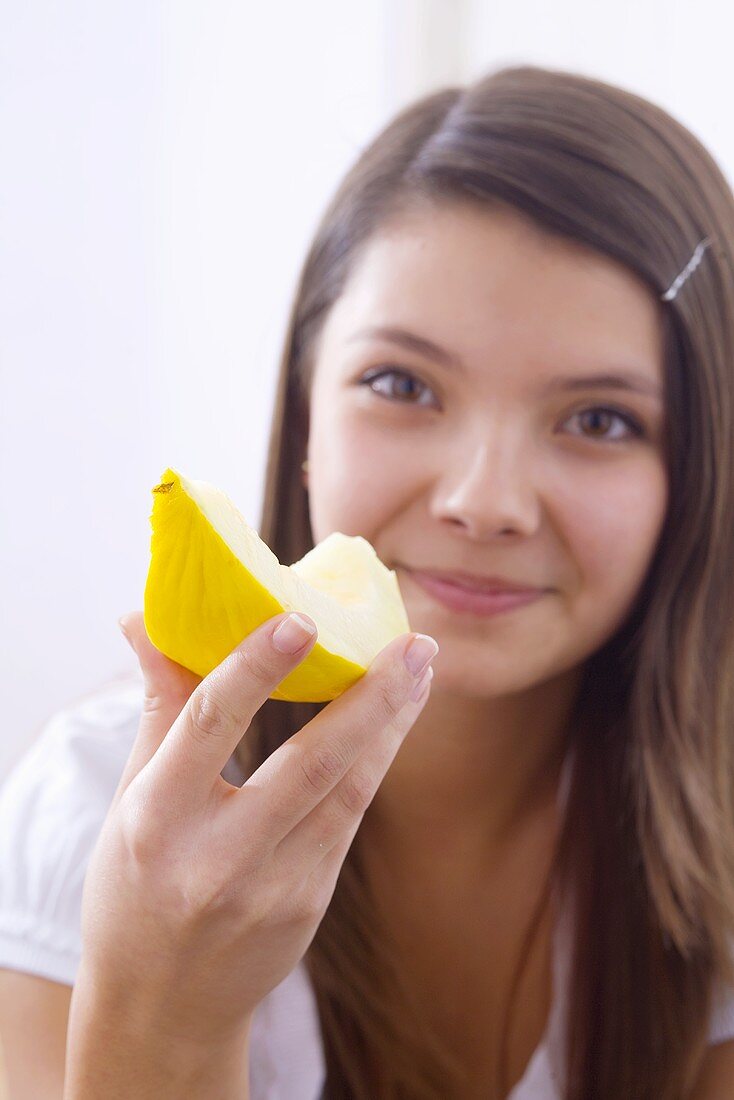 Girl holding a wedge of honeydew melon