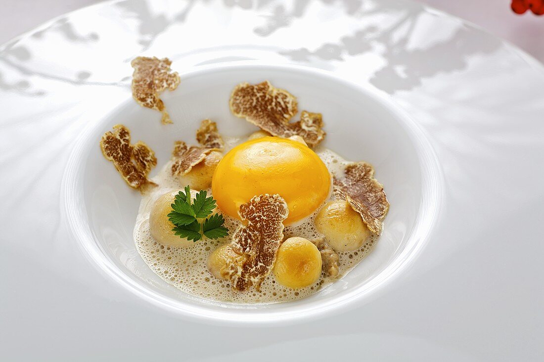 Raw egg with truffle and button mushrooms
