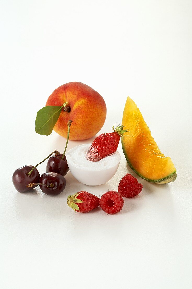 Various types of fruit, berries and sugar